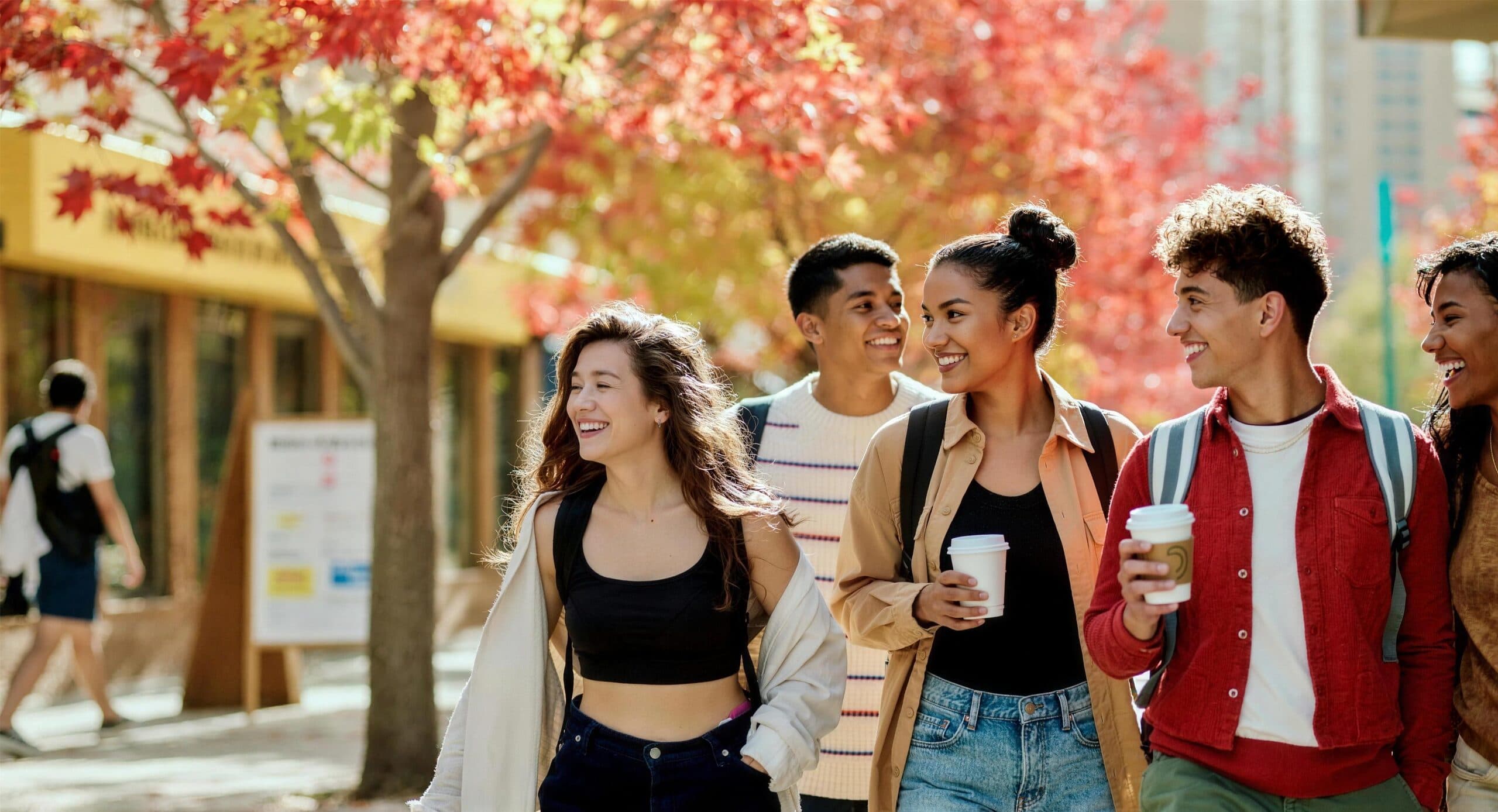 International students walking together on a sunlit Canadian autumn campus